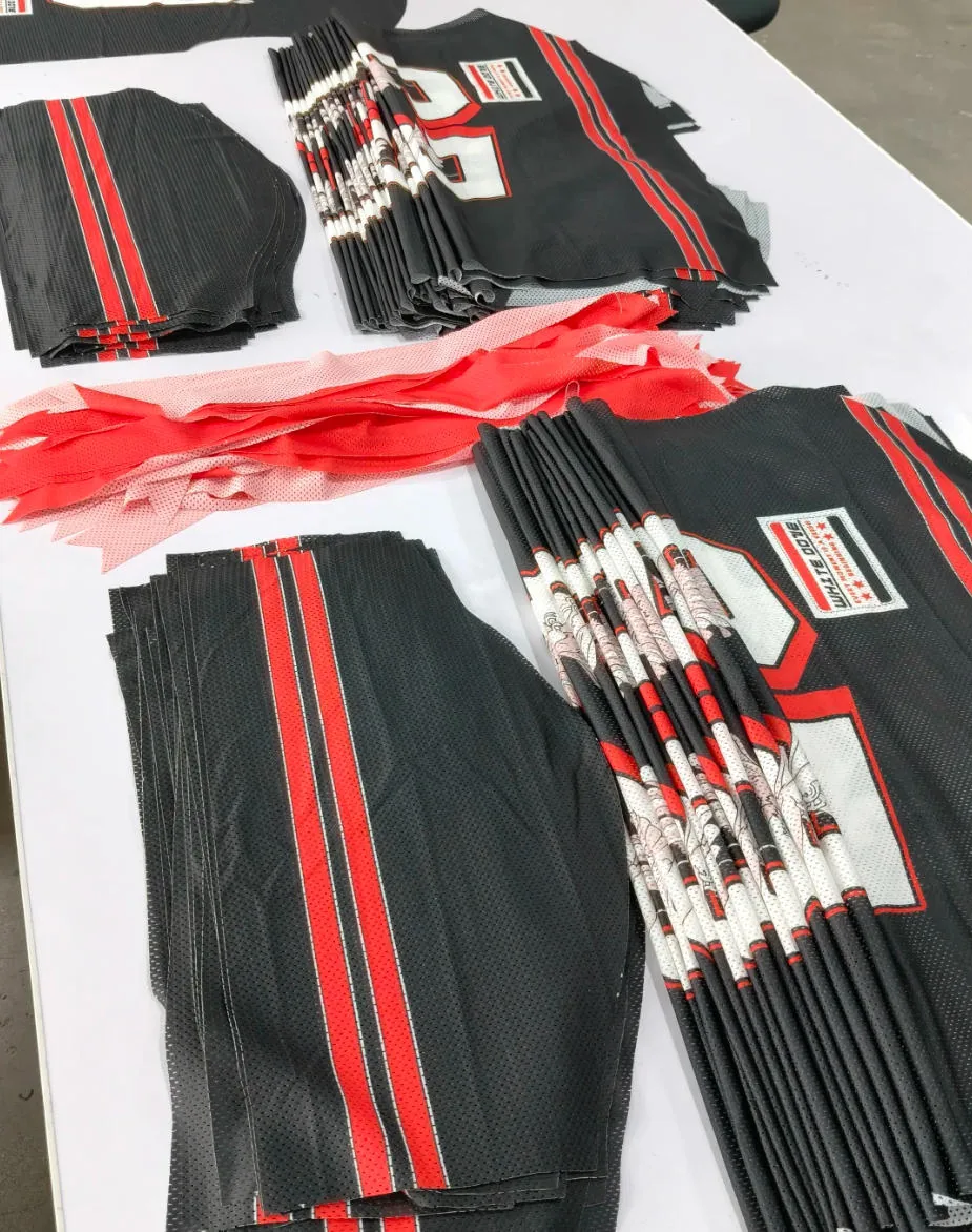 Stacks of printed jersey panels prepared for bulk cut-and-sew production