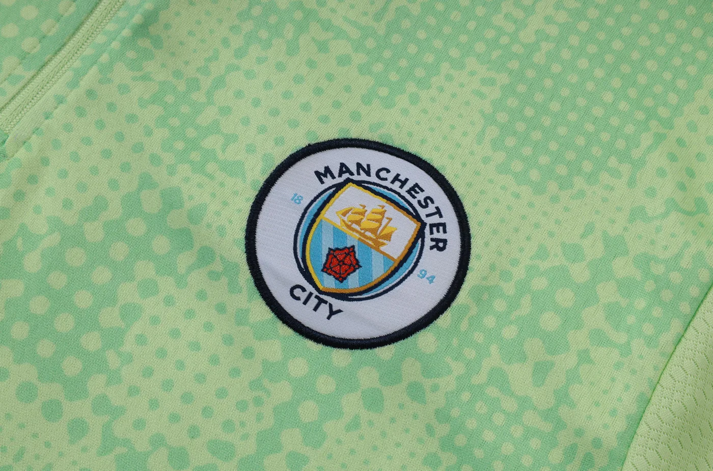 Embroidered badge detail on a football training top