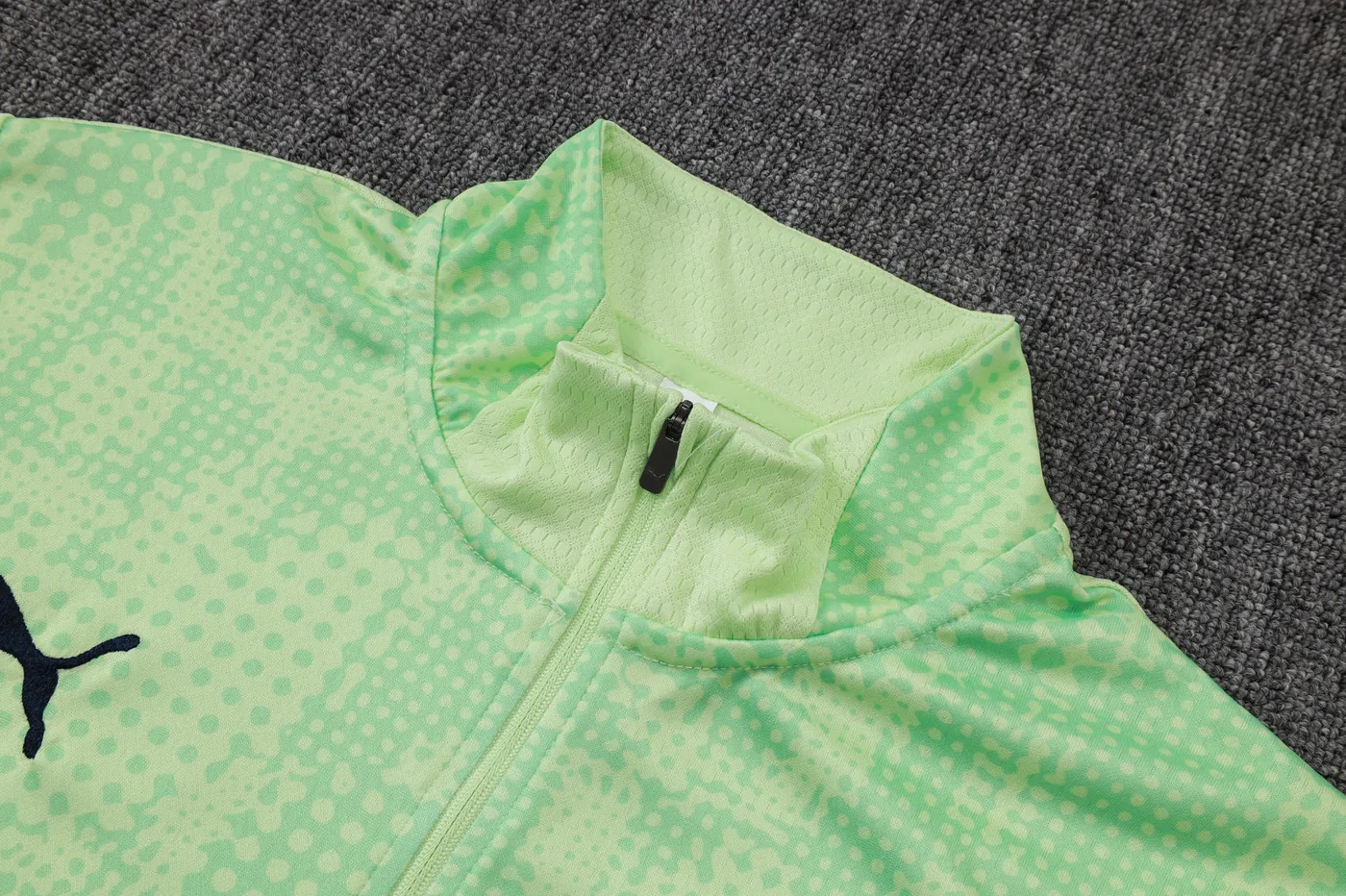 Quarter-zip collar detail on a long-sleeve football training top